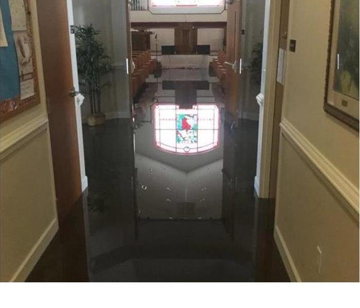 Inside of a church with water covering the floor from a storm.