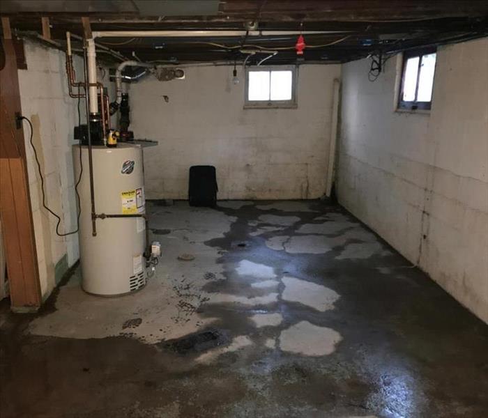 Concrete basement with damp walls and floors