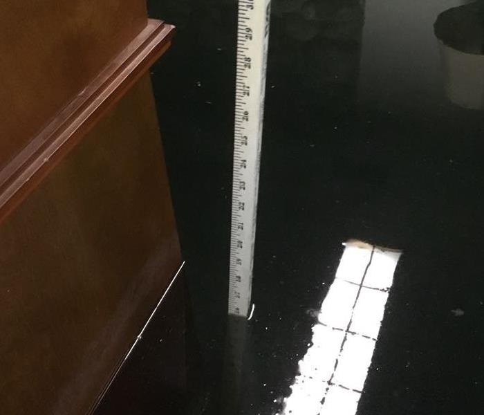 Ruler measuring two feet of water