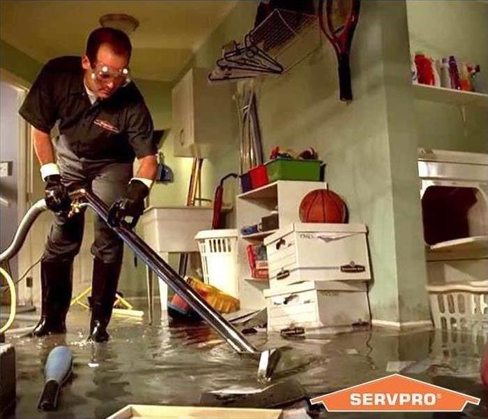 SERVPRO employee extracting water from basement.