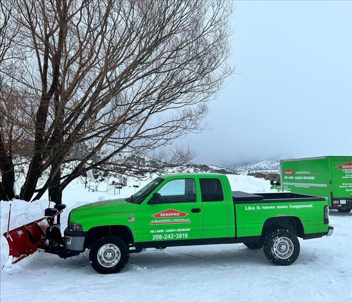 green dodge truck with a plow 